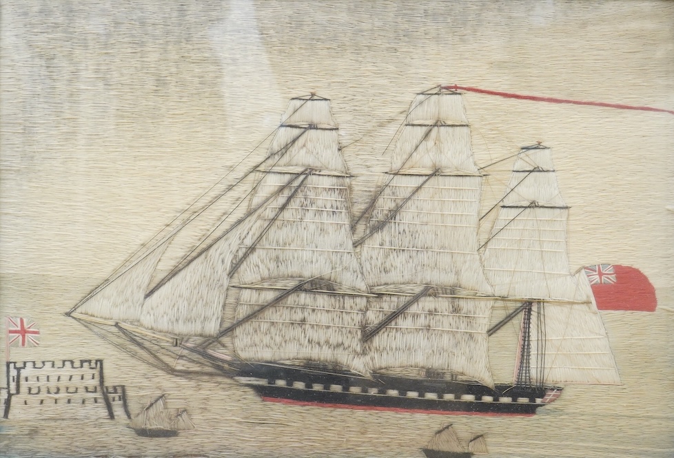 A 19th century maple framed Folk Art, sailors wool work or ‘Woolie’ of a Royal Navy cutter sailing past smaller ships in the foreground and a castle flying a Union Jack, 48cm wide x 33cm high. Condition - possibly hung o